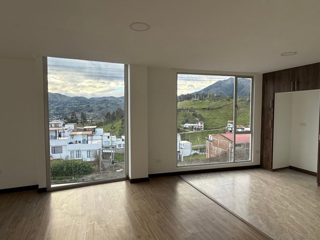 Open living area with large windows and hillside views