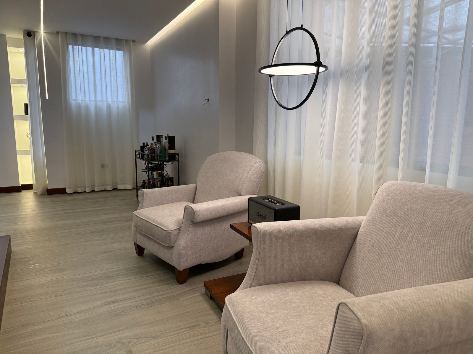 Furnished sitting area with modern lighting and large windows