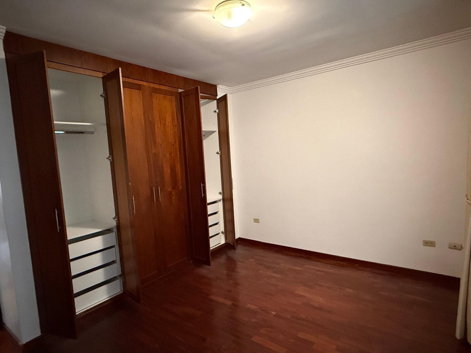 Bedroom with built-in wooden wardrobes