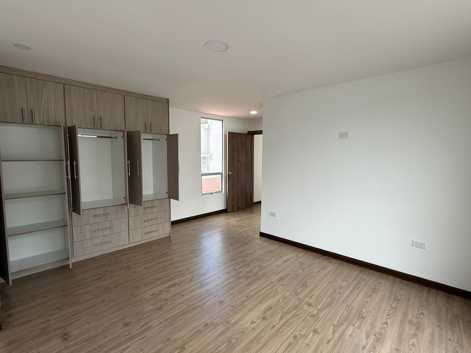 Spacious primary bedroom with built-in storage