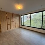 Bright primary bedroom with large windows in Parkenor, Loja