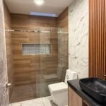 Modern full bathroom with glass shower in the Parkenor home