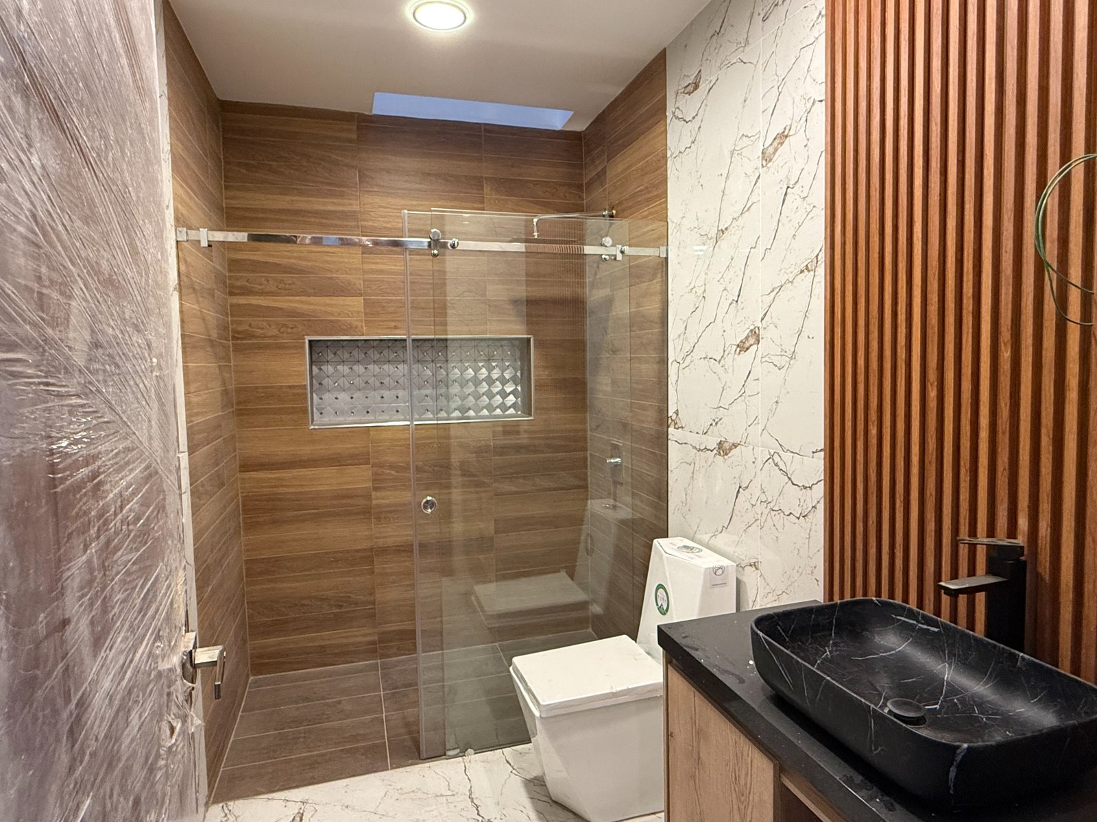 Modern full bathroom with glass shower in the Parkenor home