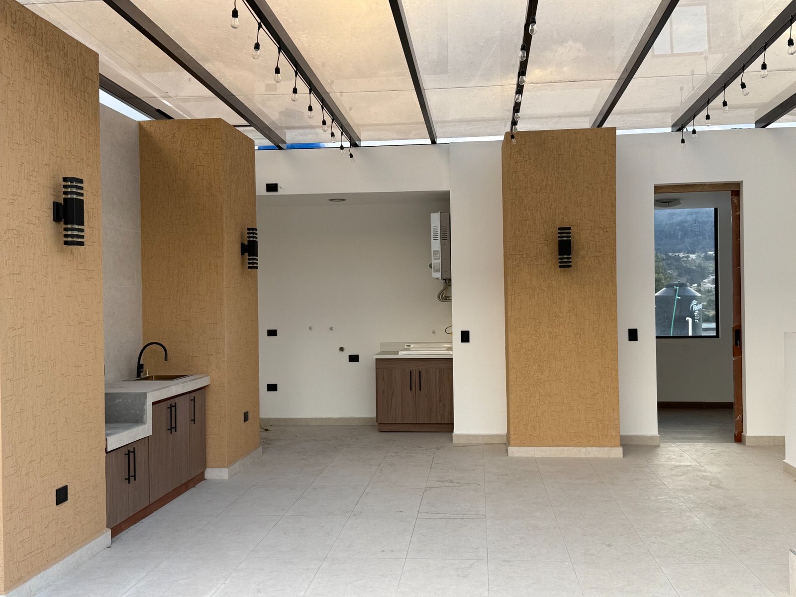 Covered rooftop terrace and barbecue area of the Parkenor house