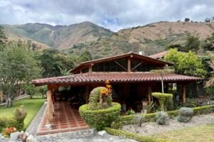 Exterior of the country house with a mountain backdrop