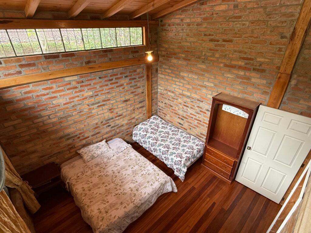 Bedroom with wood furniture and a garden-facing window