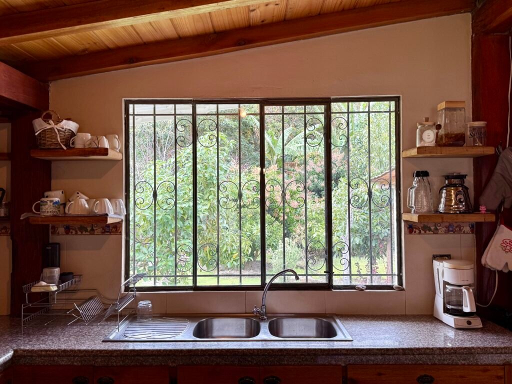 Window view across the garden and mountain landscape
