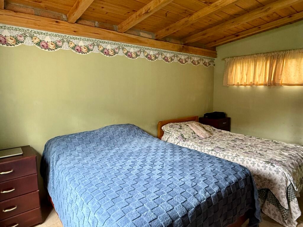 Bedroom with a wooden bed and garden views