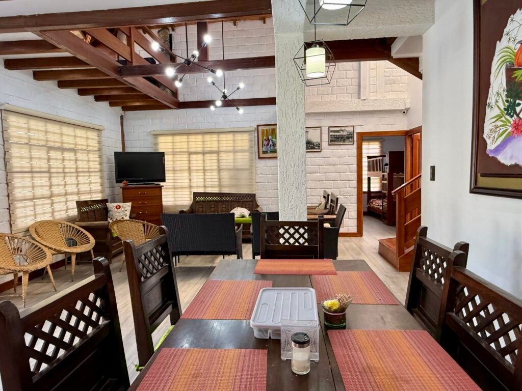 Open dining and living area with exposed ceiling beams