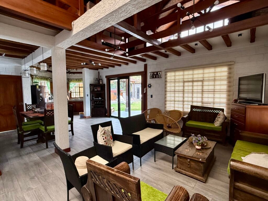 Furnished living and dining area with exposed wooden beams