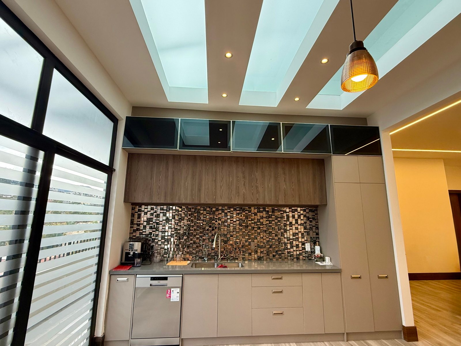 Modern kitchen with skylights and extensive cabinetry