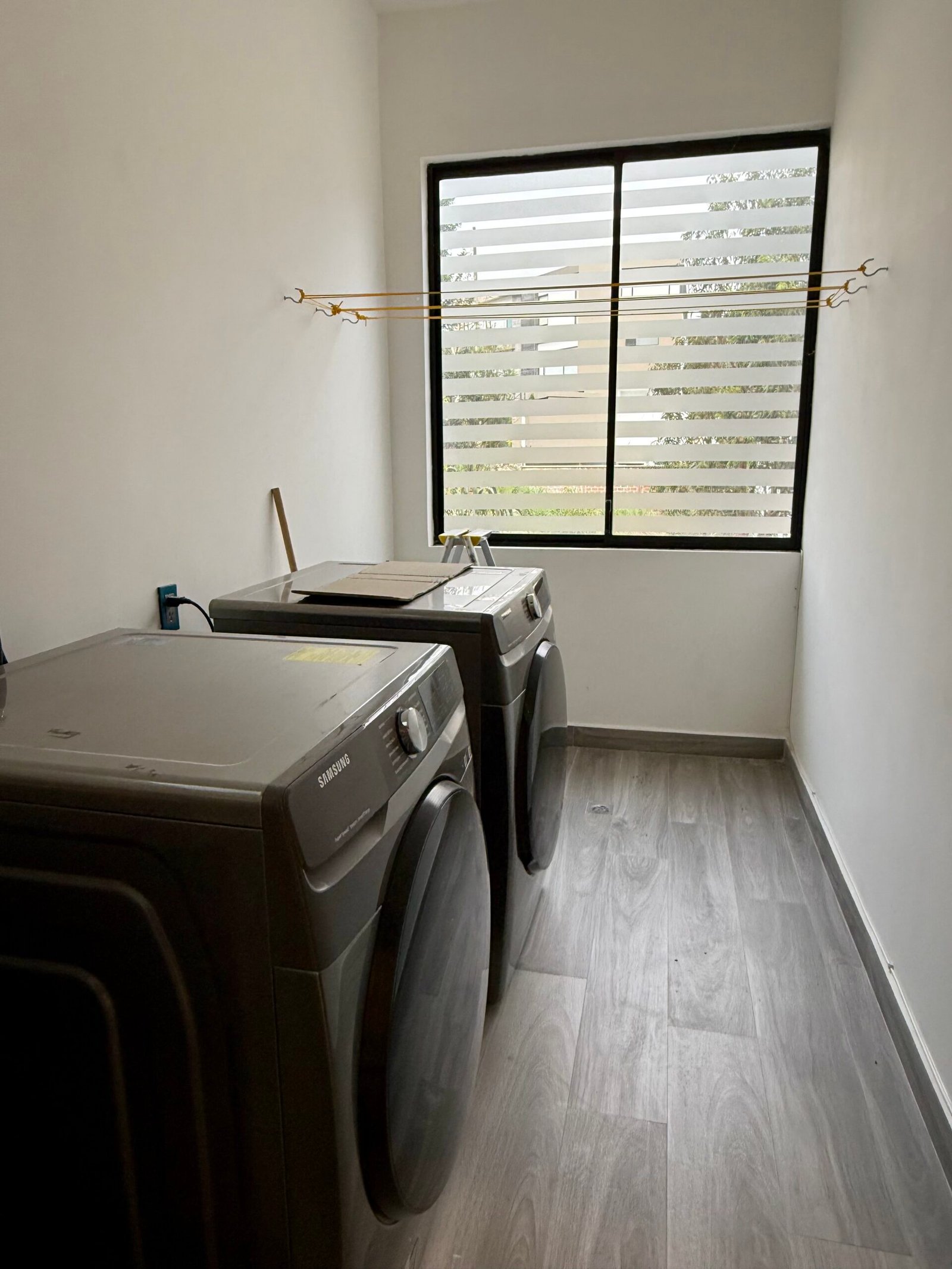 Laundry and utility area with a window