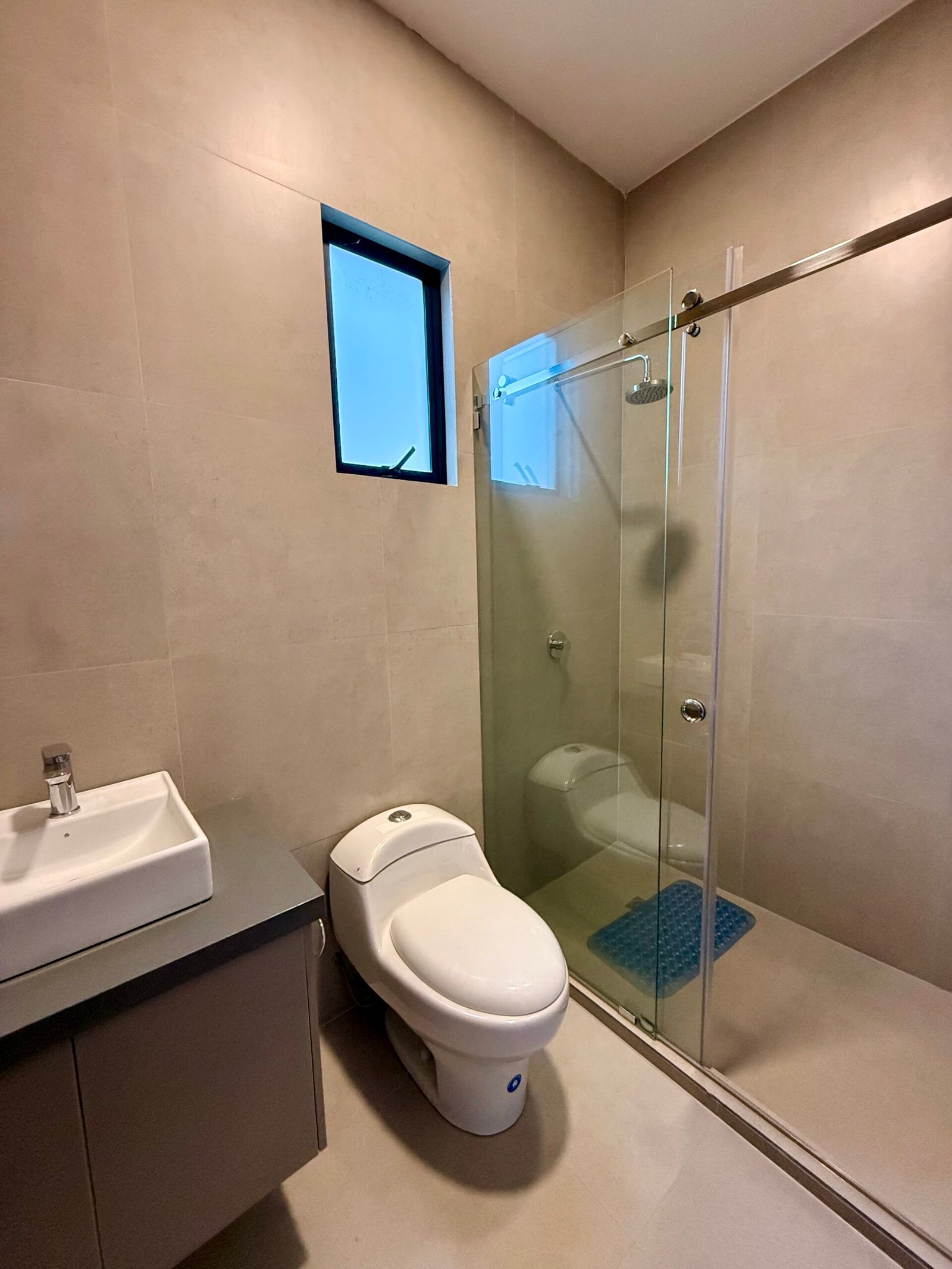 Modern bathroom with tiled walls and natural light