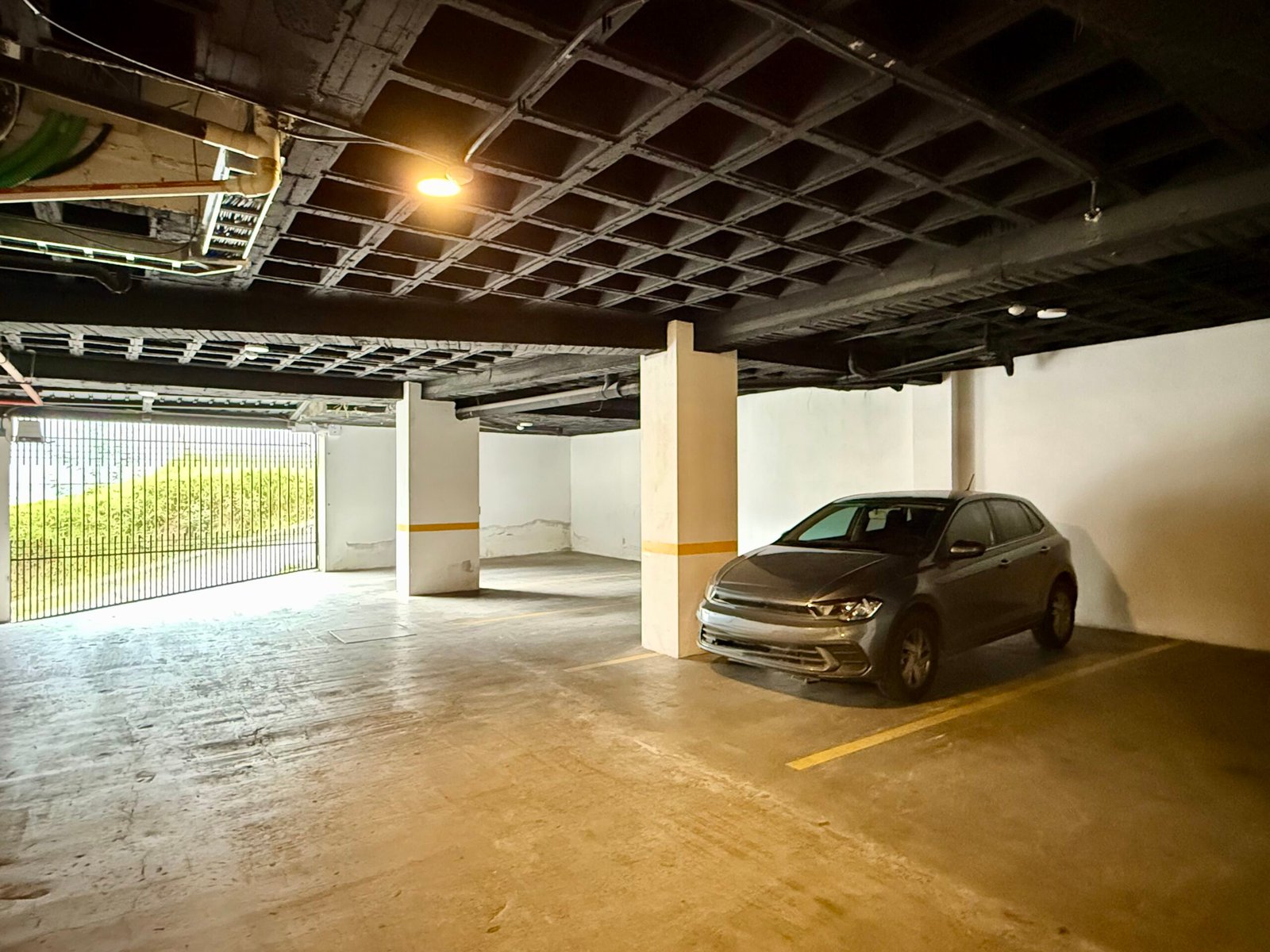 Covered parking area on the building's ground floor