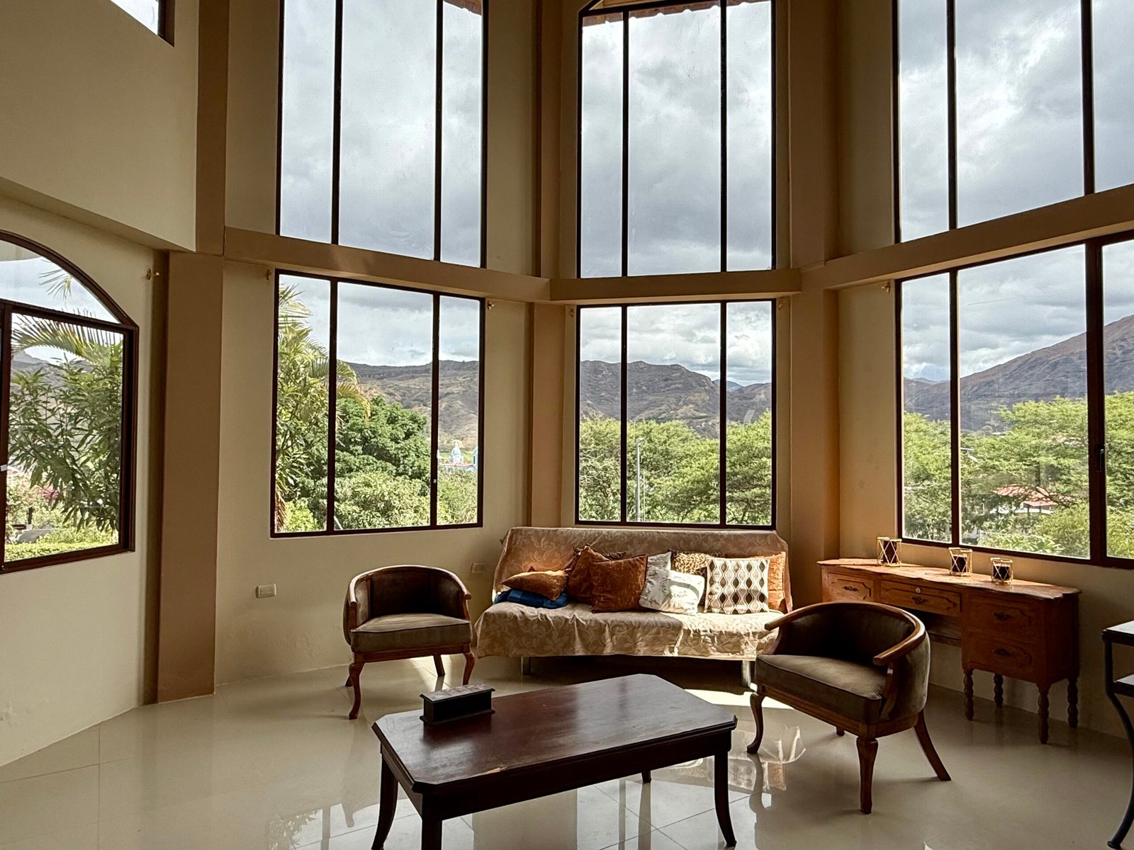 Mountain scenery framed by a large arched window