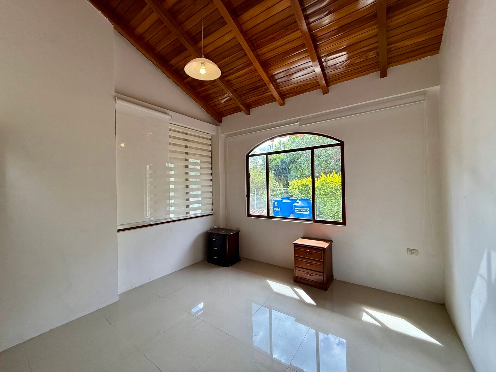 Vaulted wood ceiling and arched window upstairs
