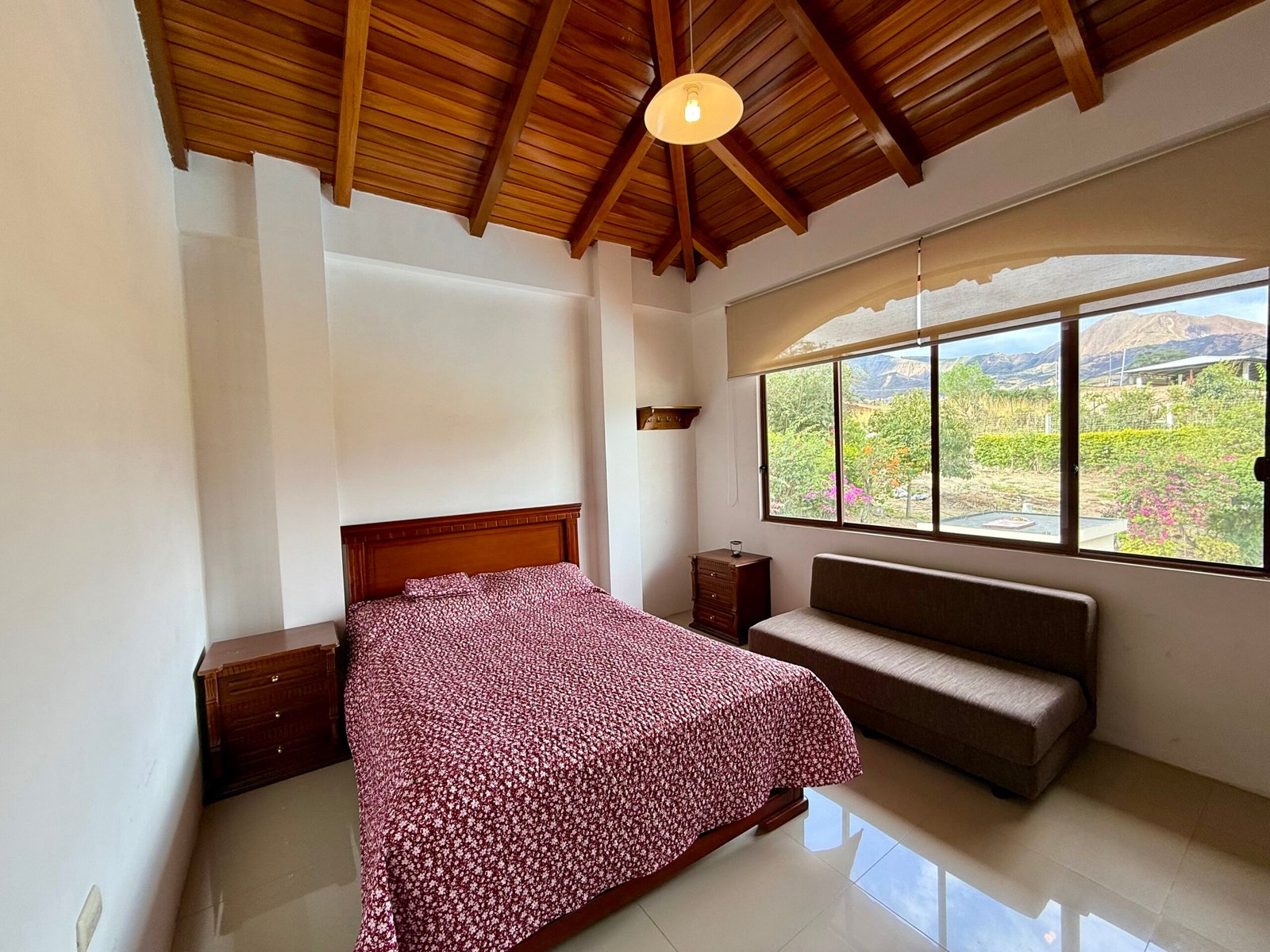 Upper-level room with a wood-beamed ceiling