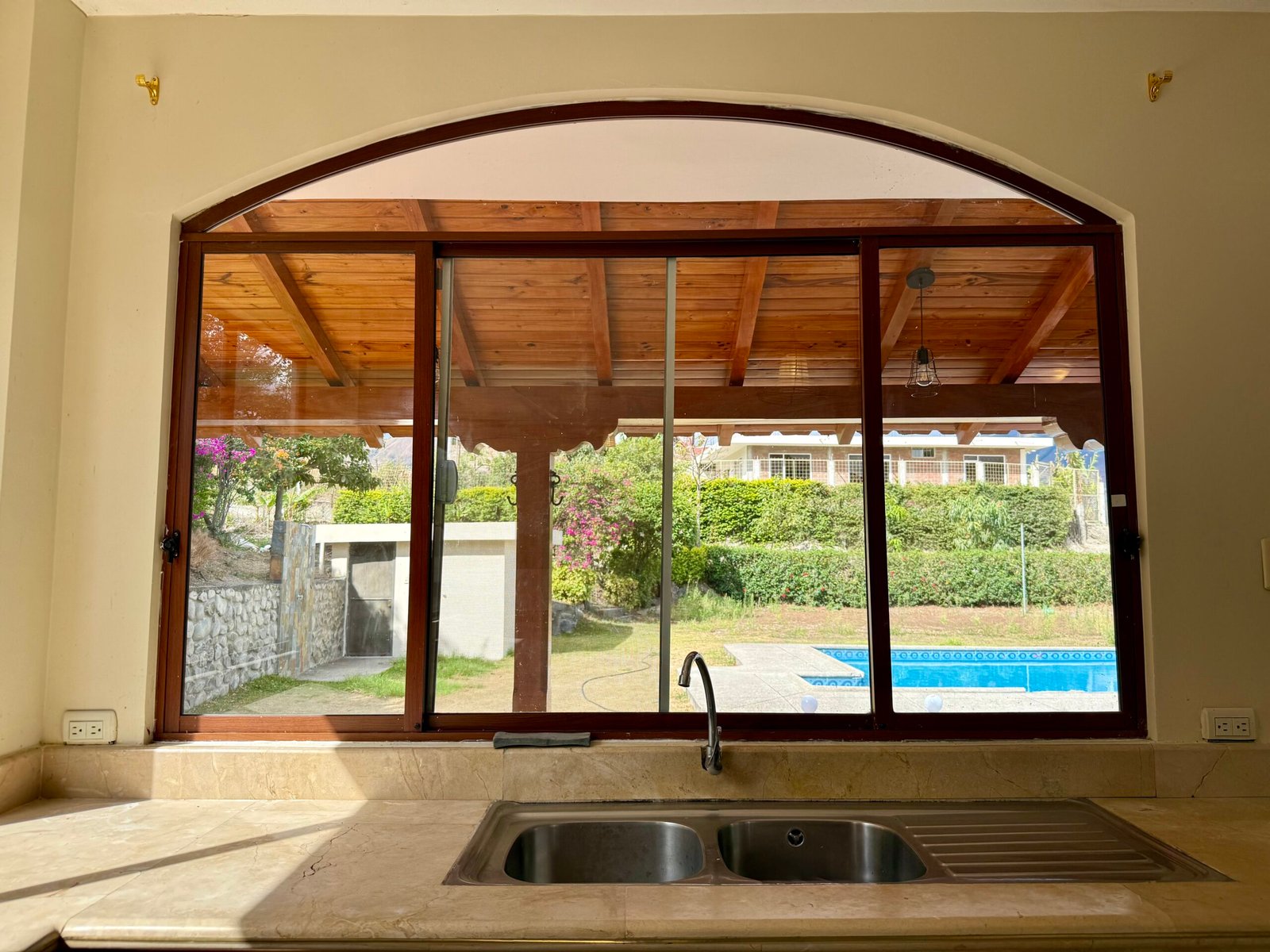 Arched picture window framing mountain views