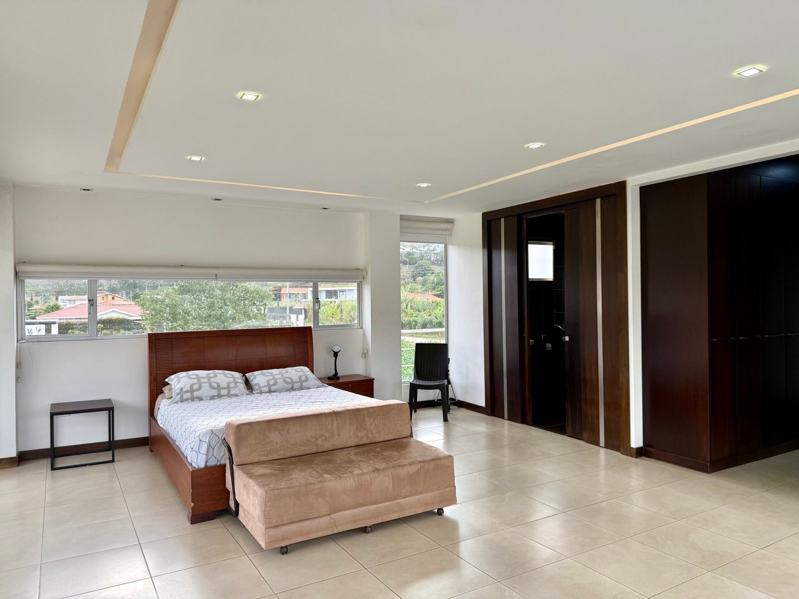 Bright bedroom with recessed lighting and built-in wardrobes