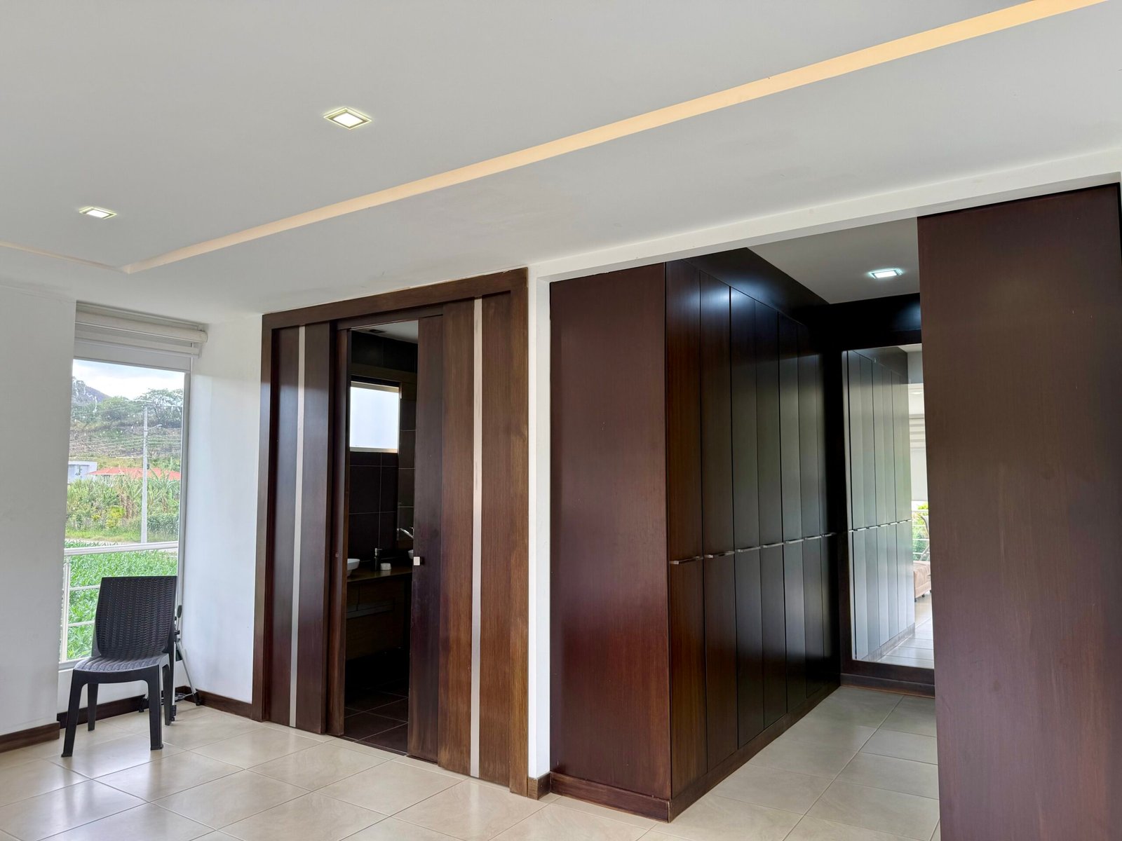 Bedroom with dark wood built-in wardrobes
