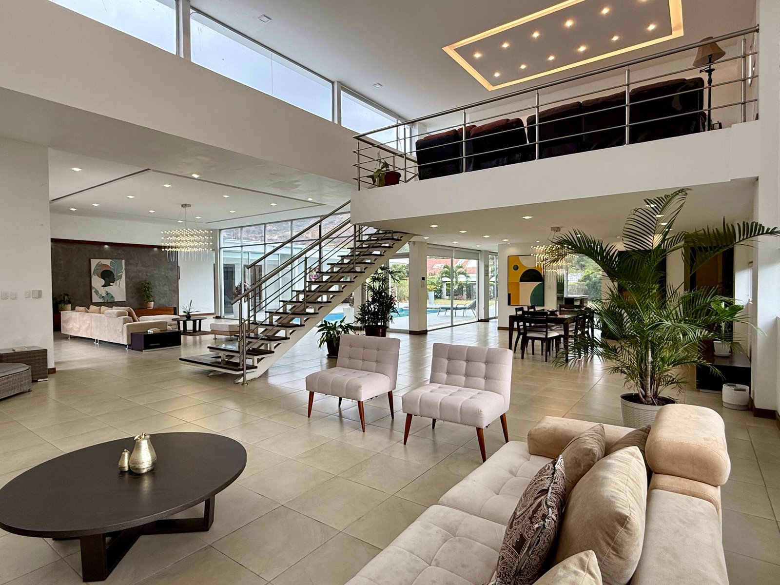 Double-height open-plan living area with staircase