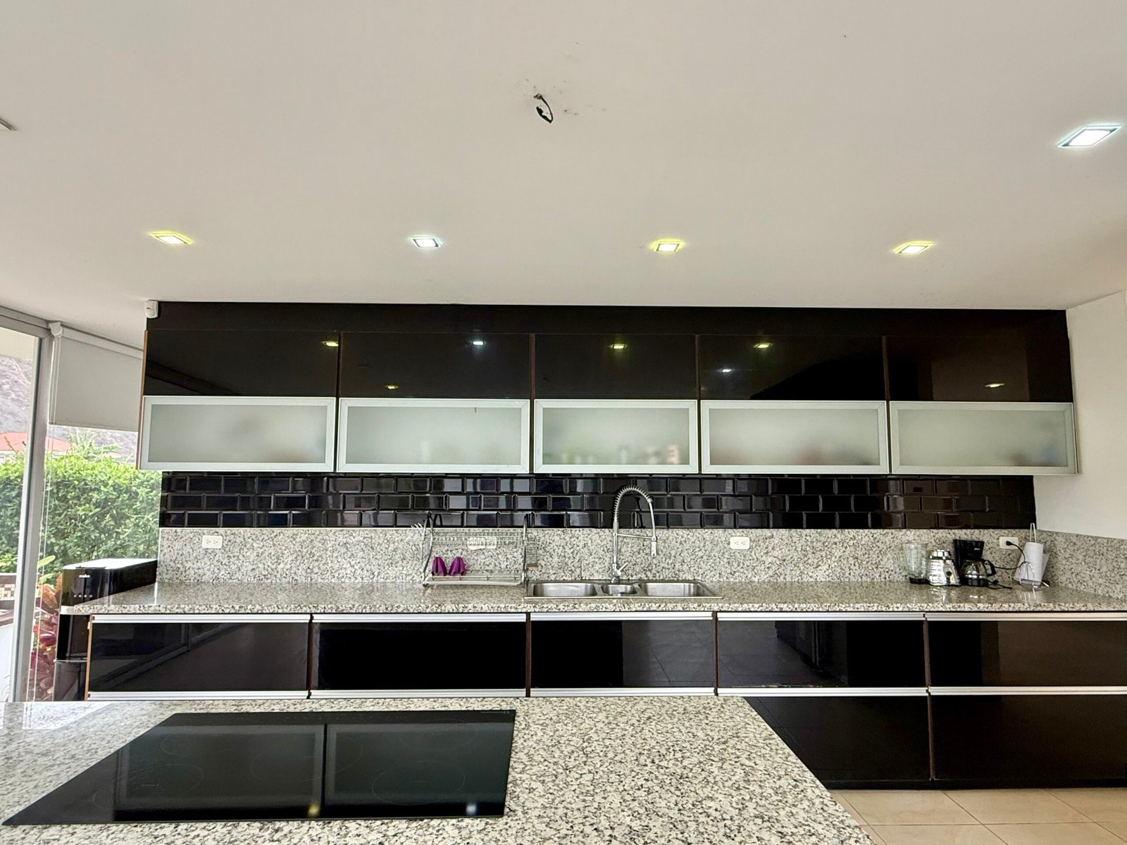 Modern kitchen with dark cabinetry and long countertop