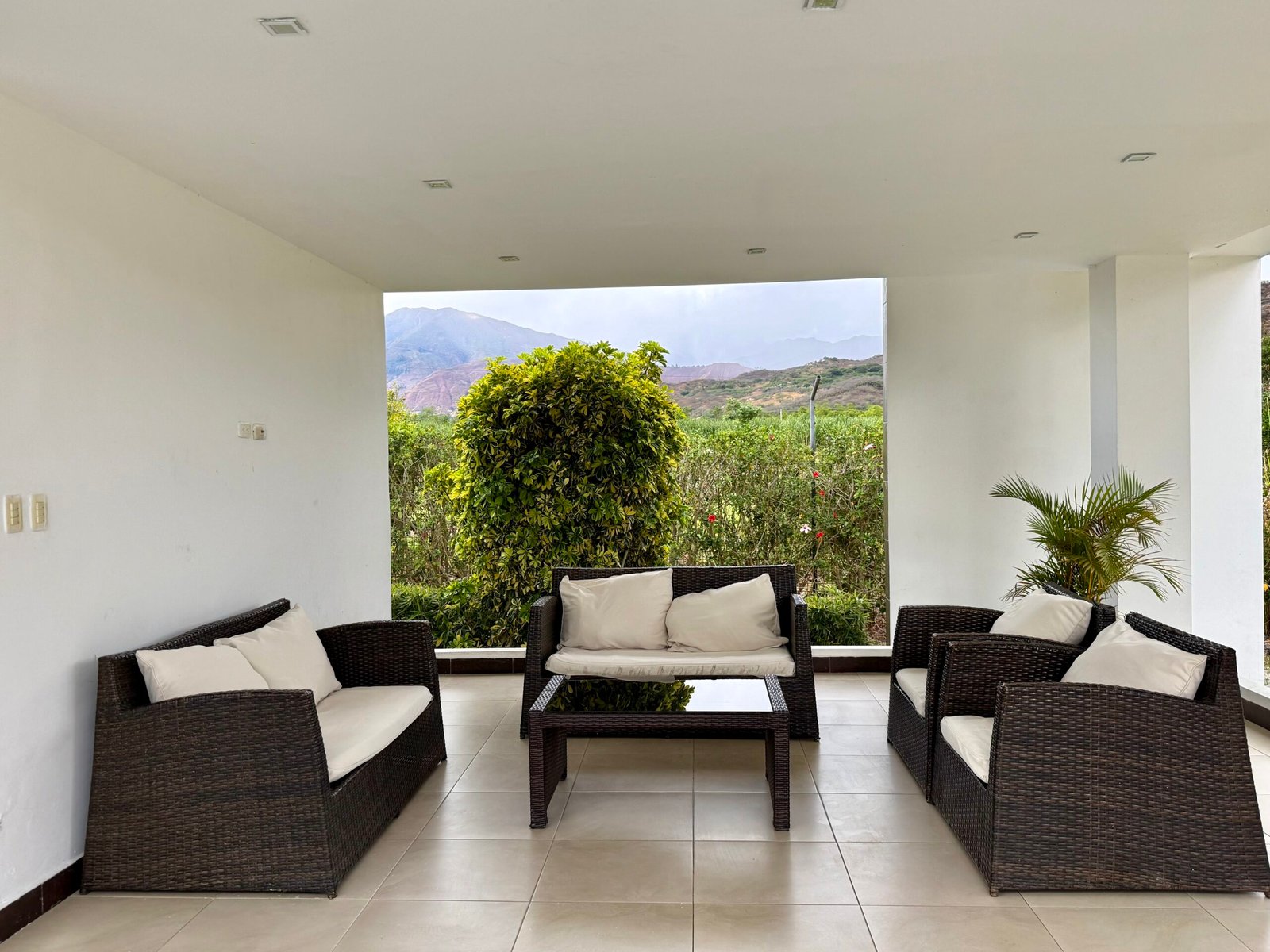 Covered outdoor lounge beside the swimming pool