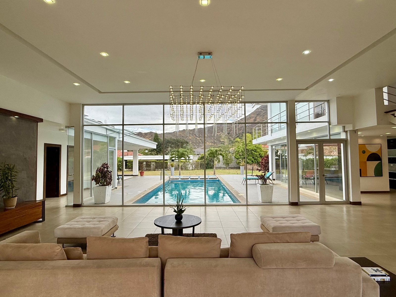Dining area with floor-to-ceiling views of the pool