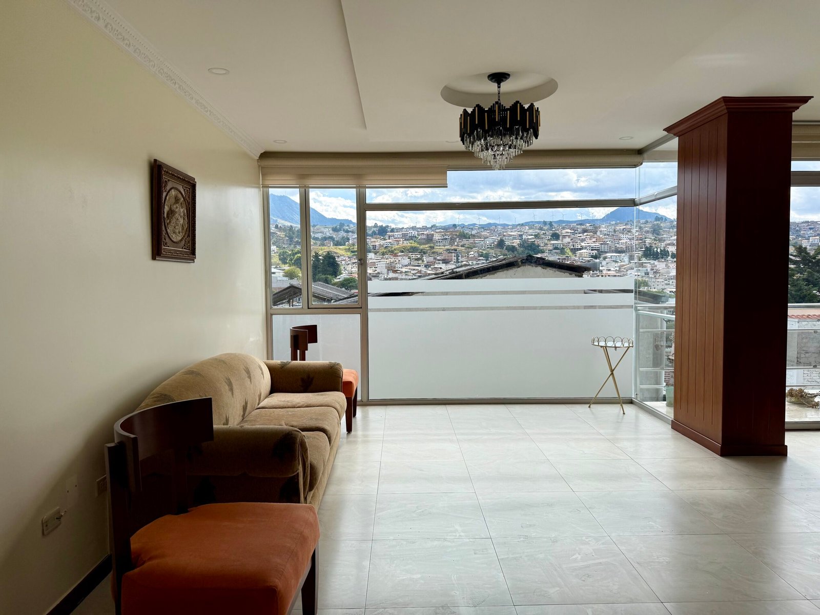 Furnished living room with balcony and city view