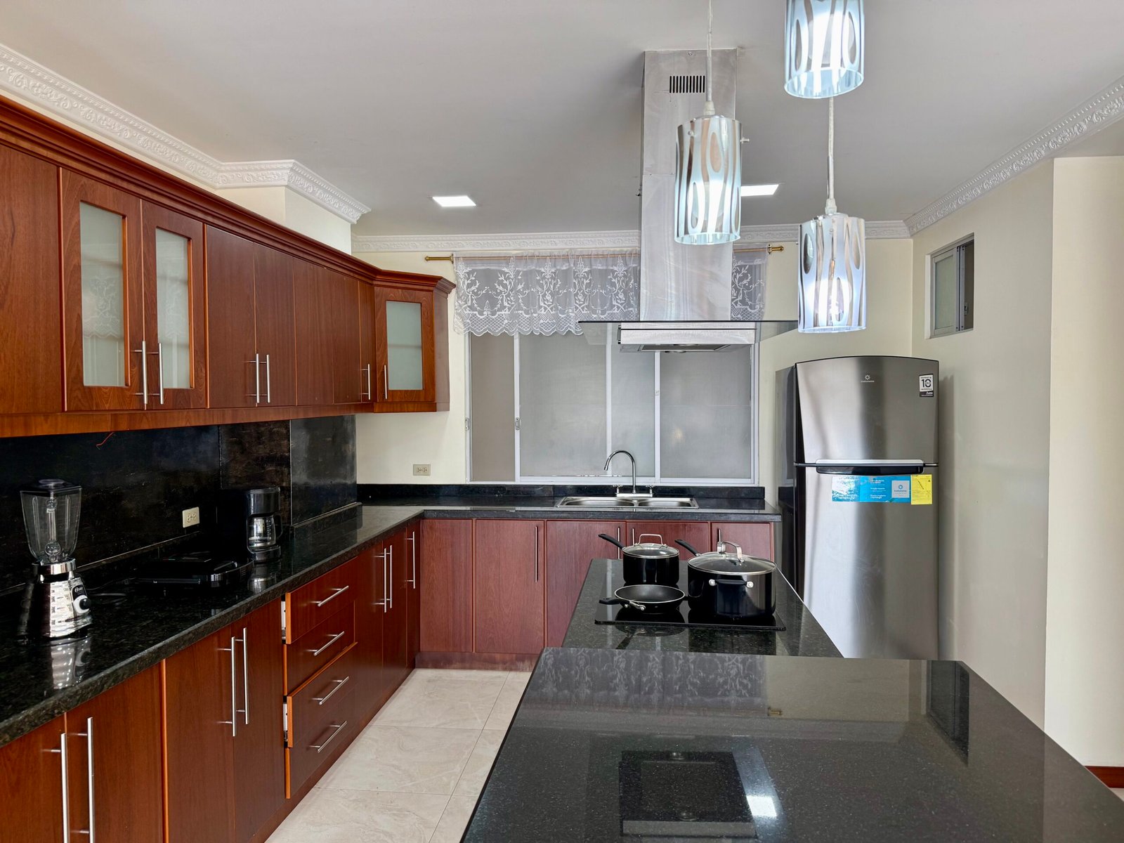 Equipped kitchen with induction cooktop and appliances