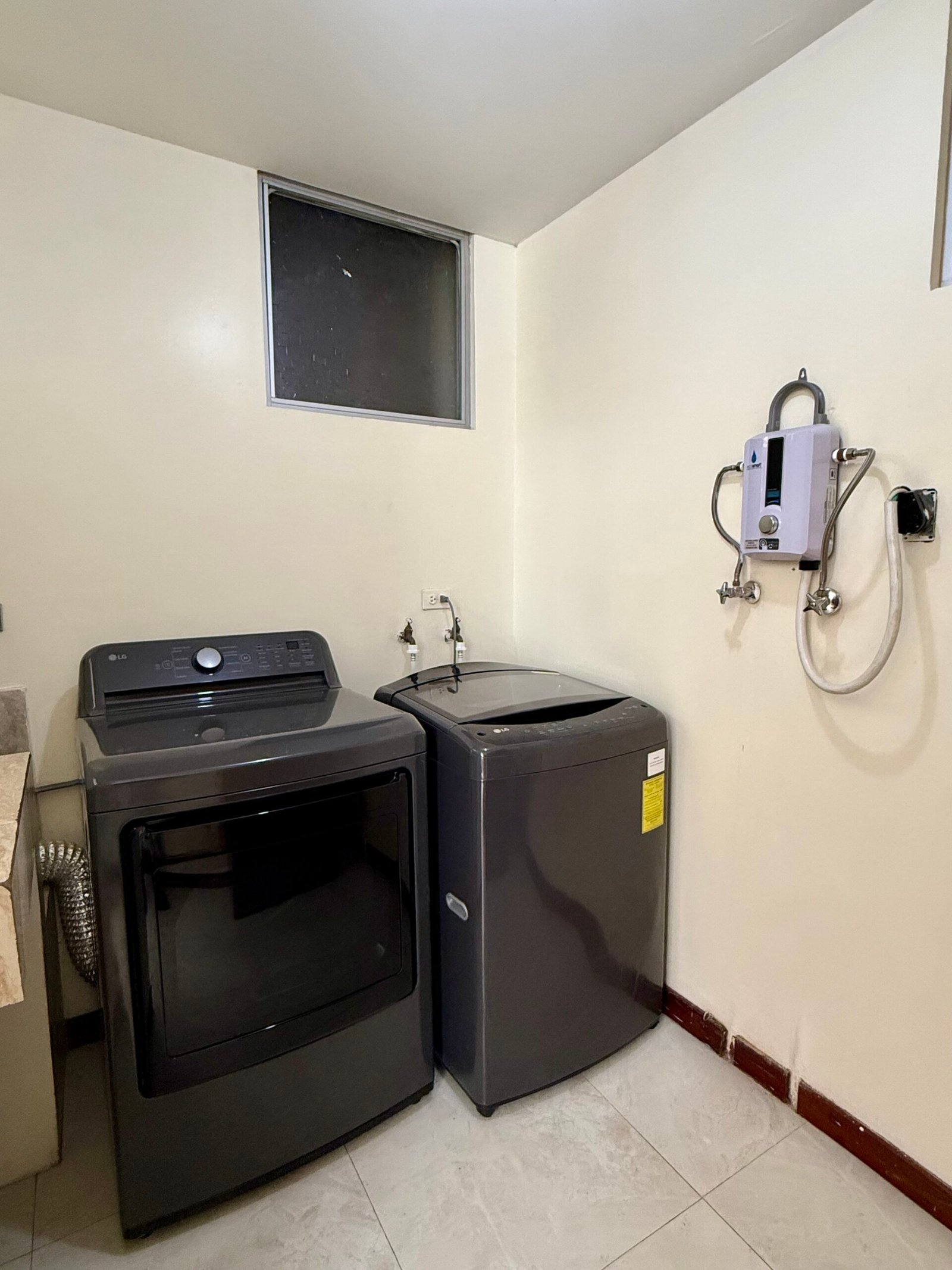 Laundry area with washer, dryer and electric water heater