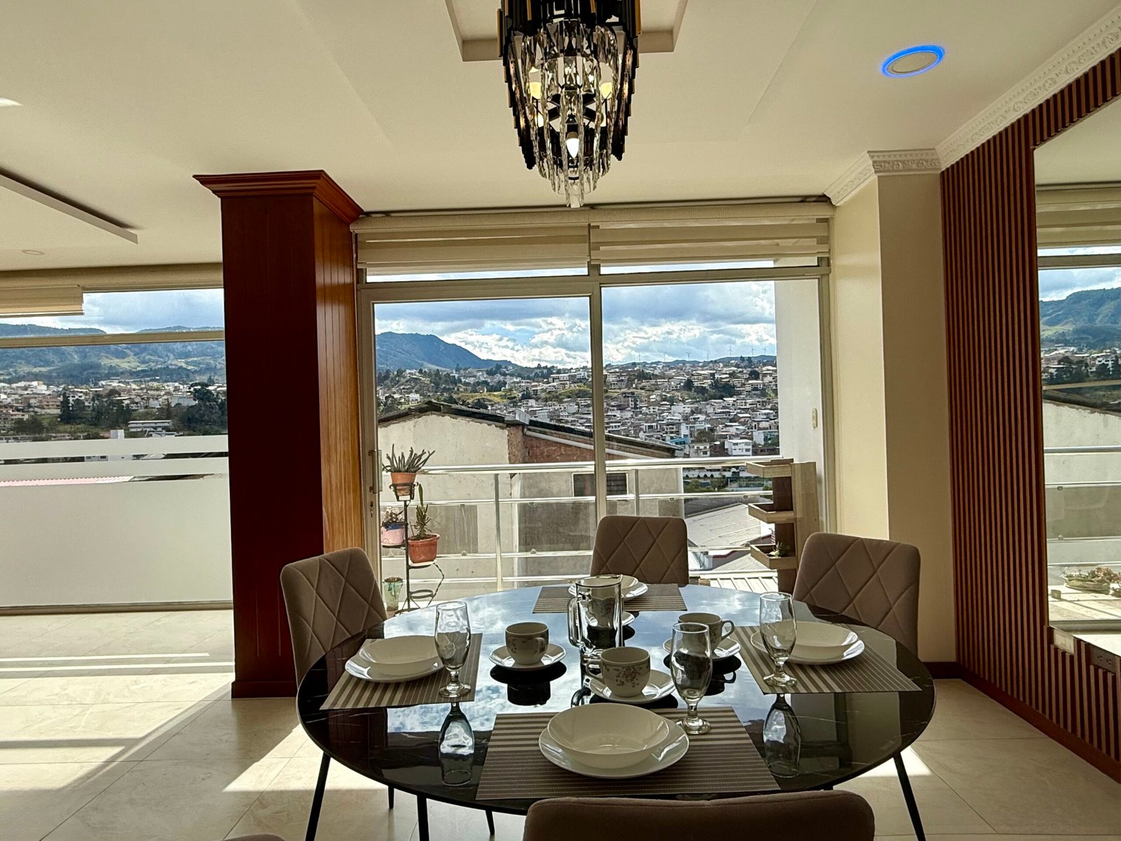 Dining area beside a balcony with city views