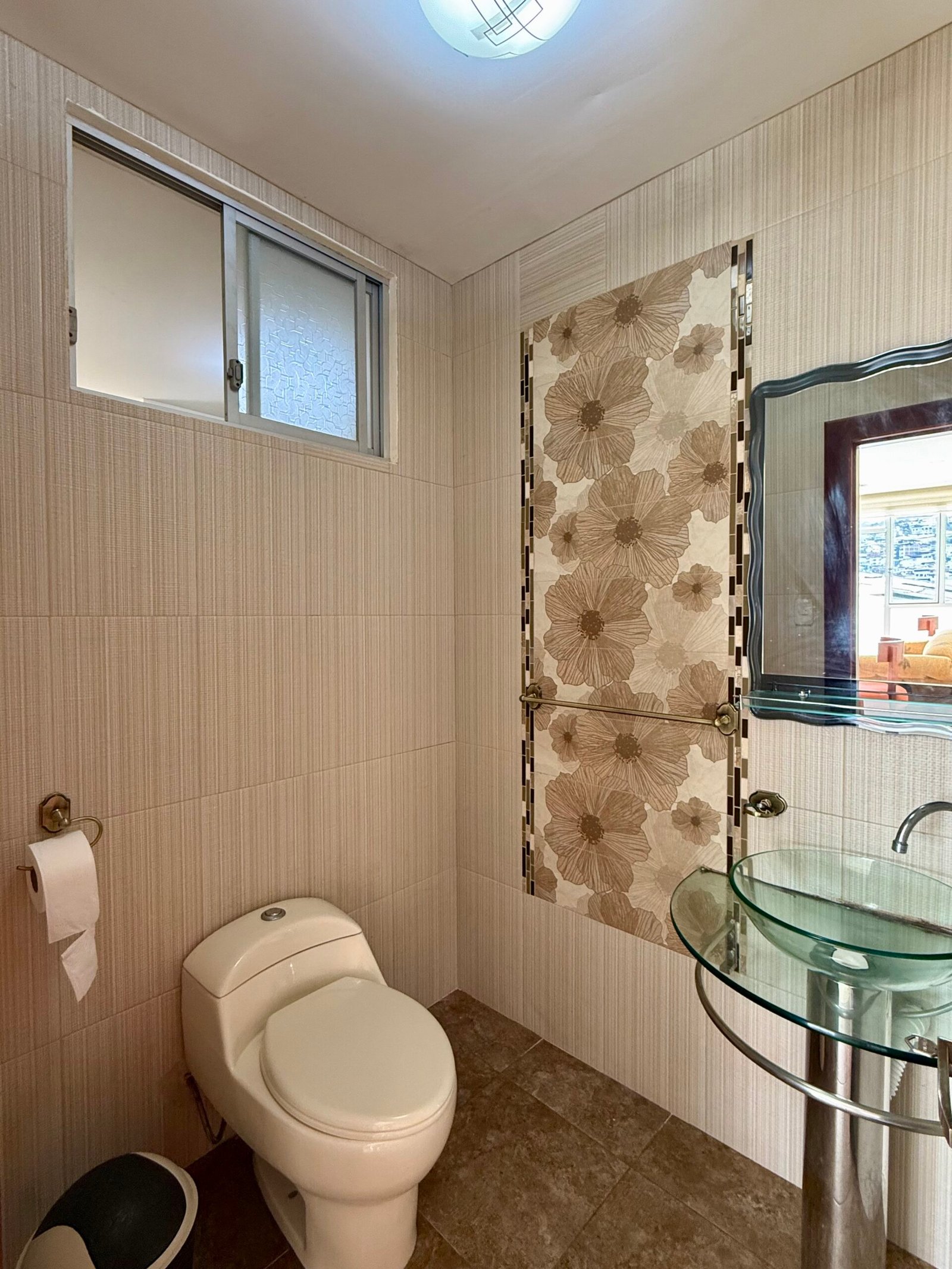 Bathroom with a tiled shower and window