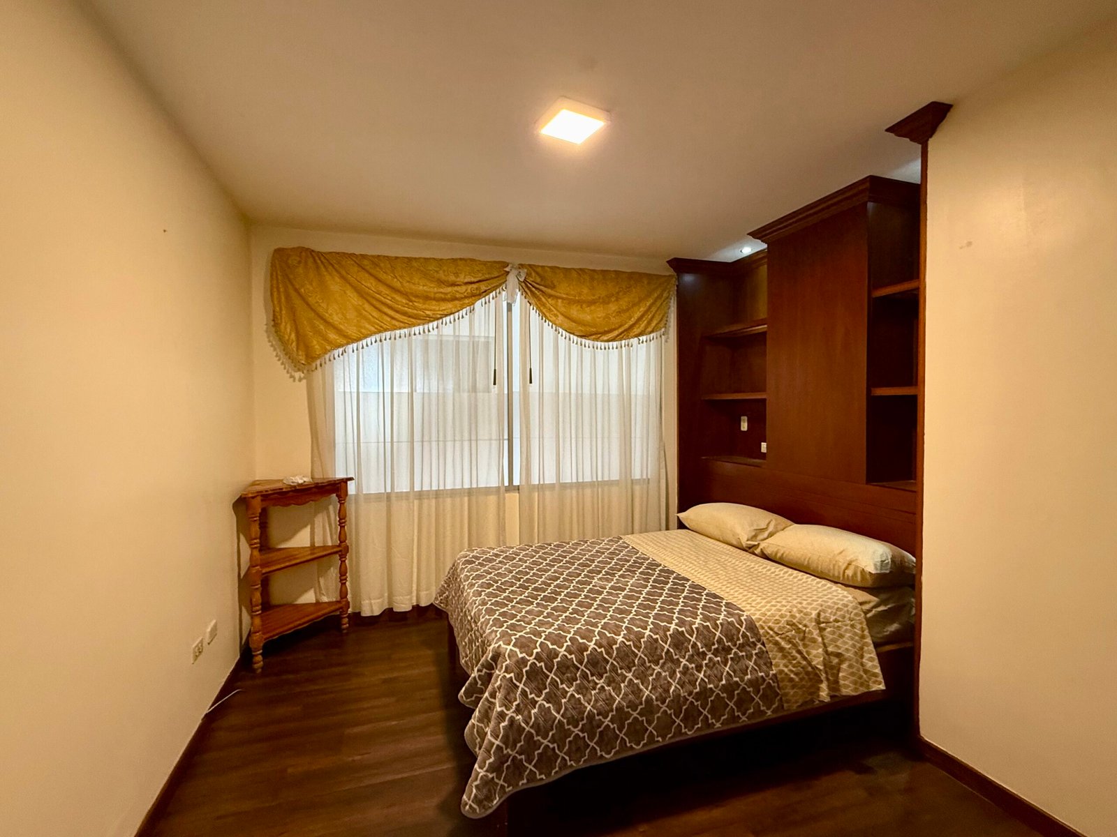 Furnished bedroom with a large window