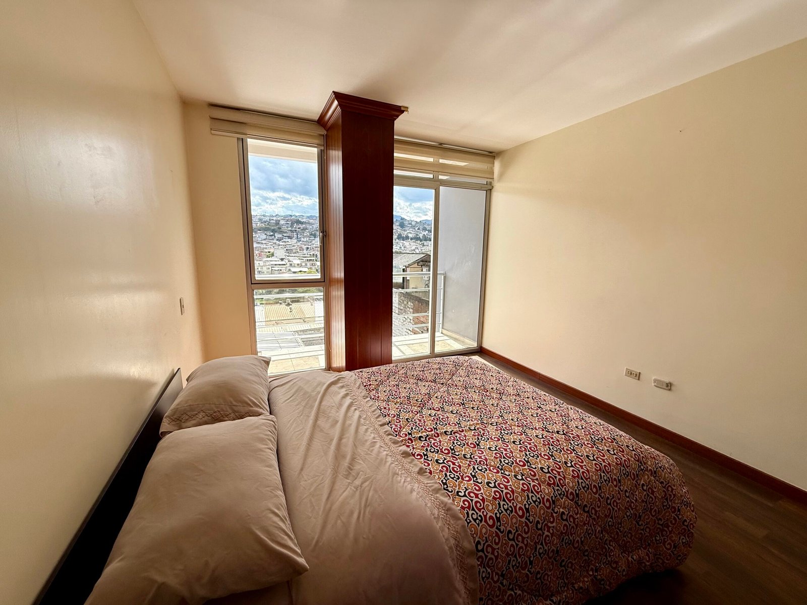 Furnished bedroom with balcony access