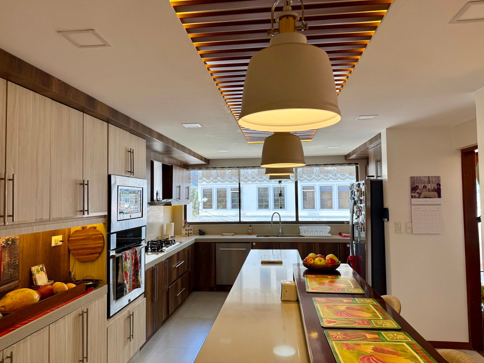 Equipped kitchen with central island and wood cabinetry