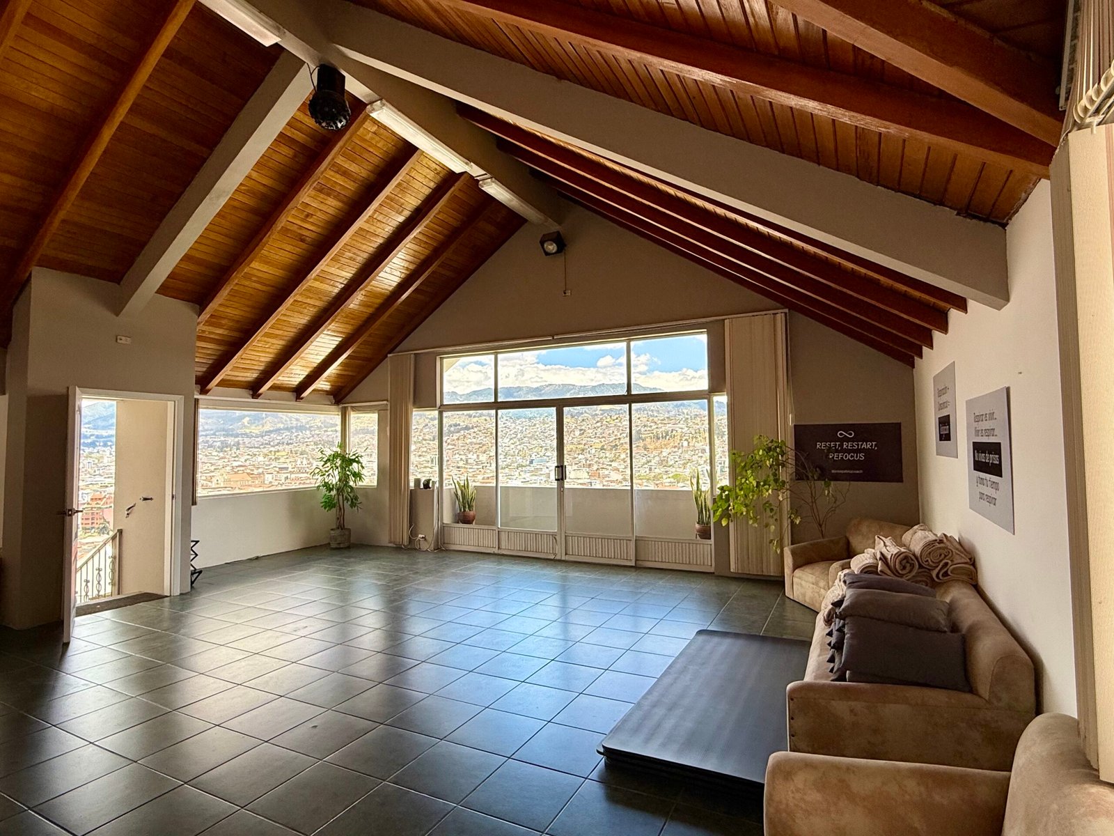 Event hall with wood ceiling and windows overlooking Loja