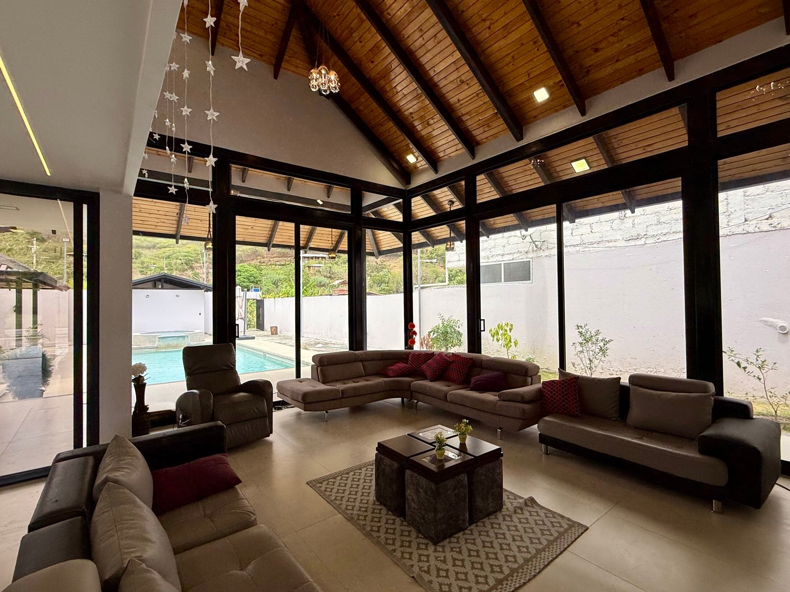 Covered outdoor living room with wood ceiling at the Country Club house in Malacatos