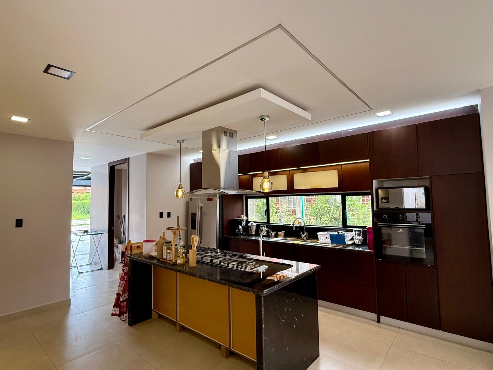 Kitchen cabinetry and large windows facing the pool