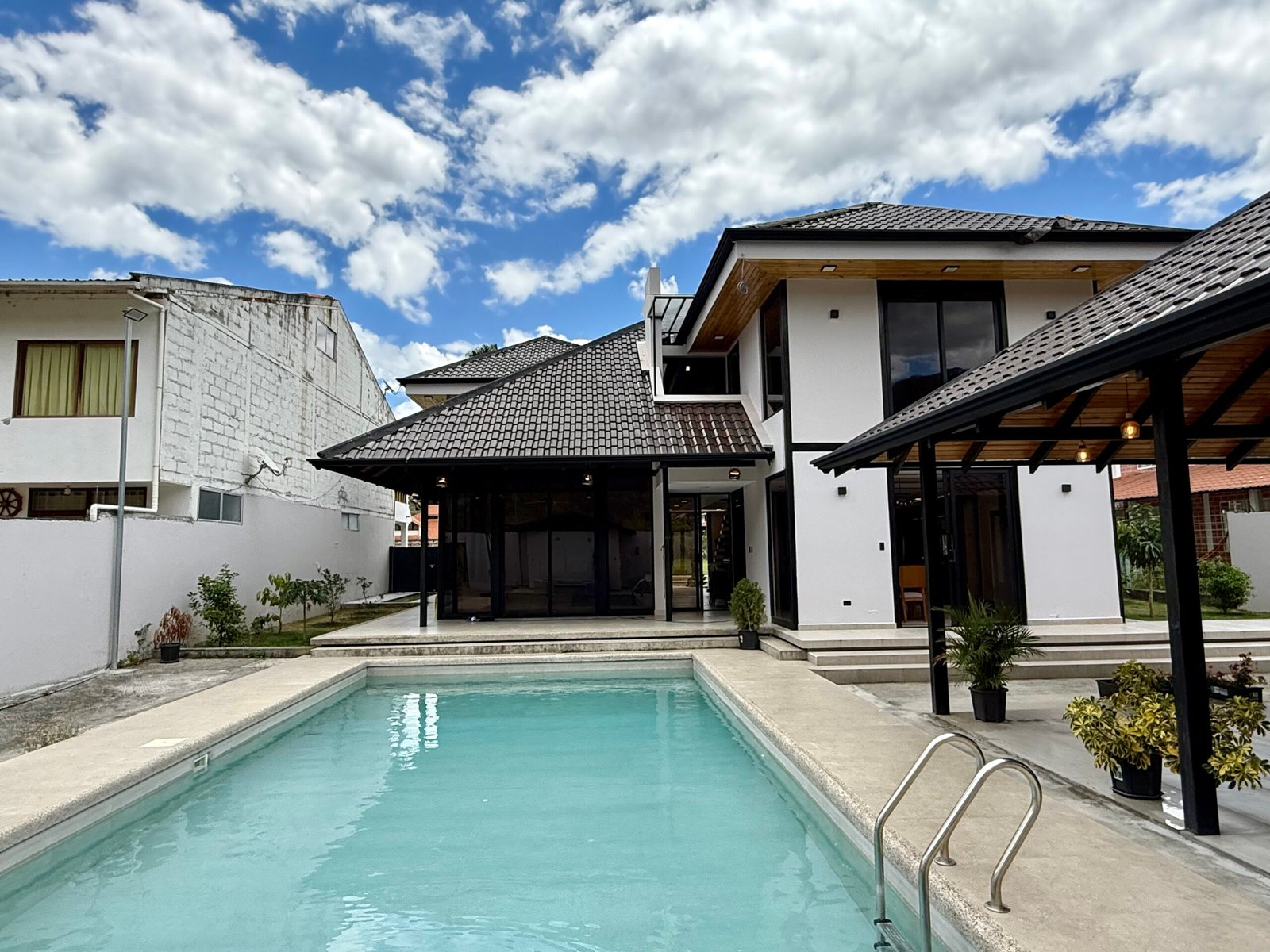 Exterior of the two-story Country Club house beside the swimming pool