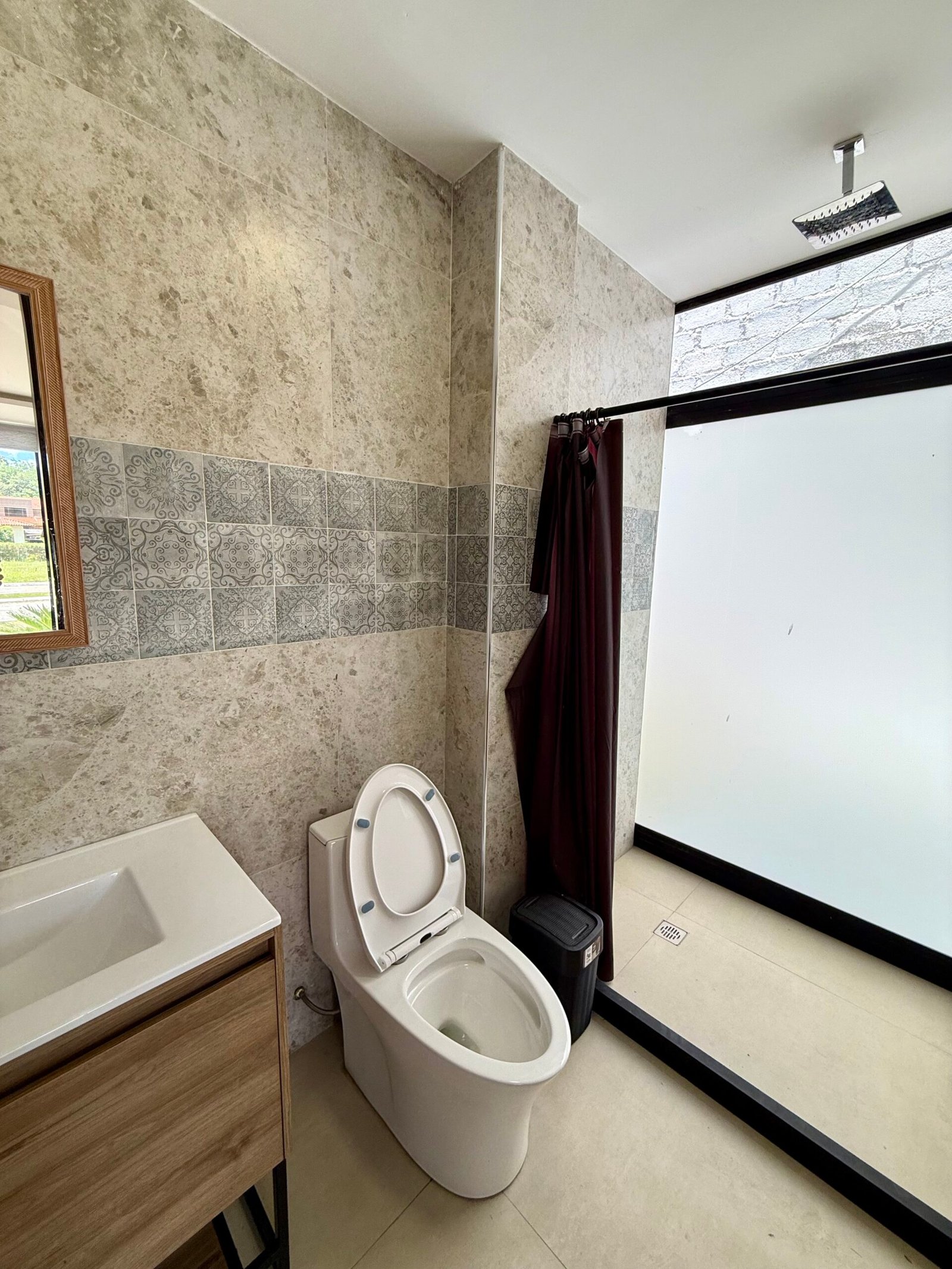 Full en-suite bathroom with bathtub and natural light