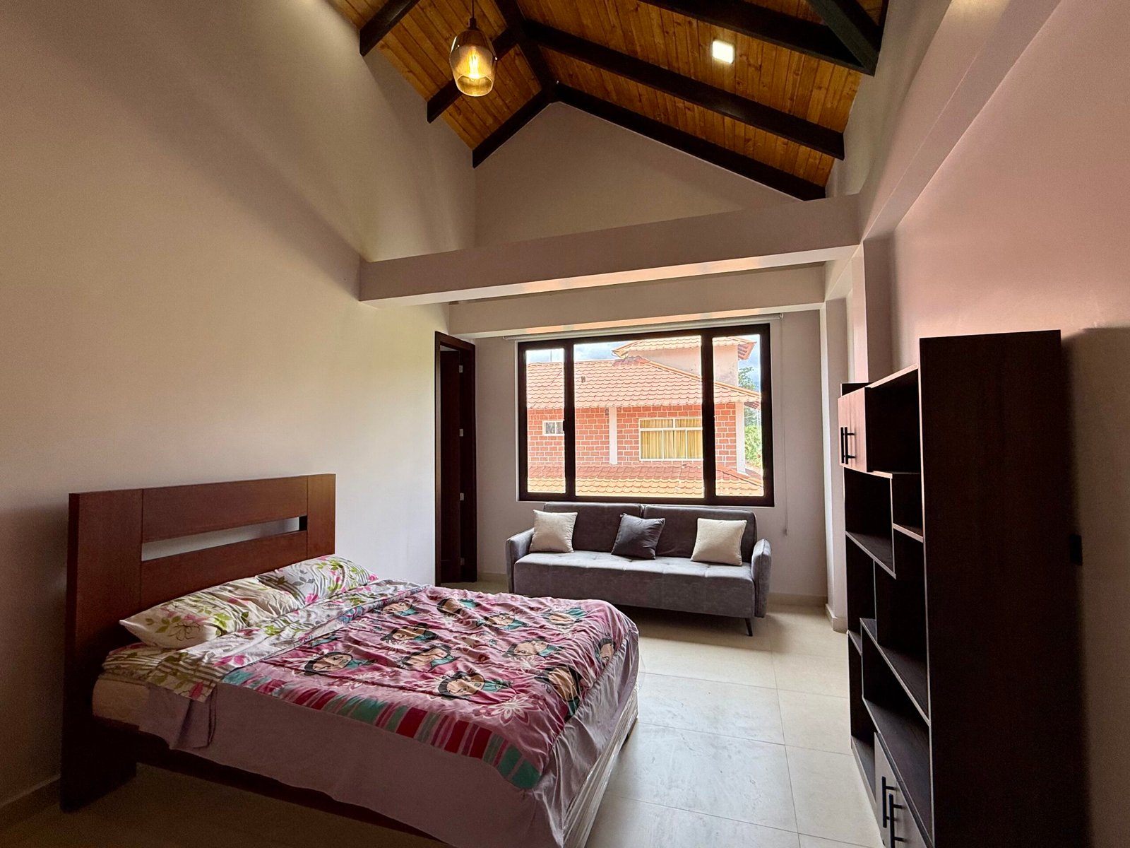 En-suite bedroom with vaulted wood ceiling