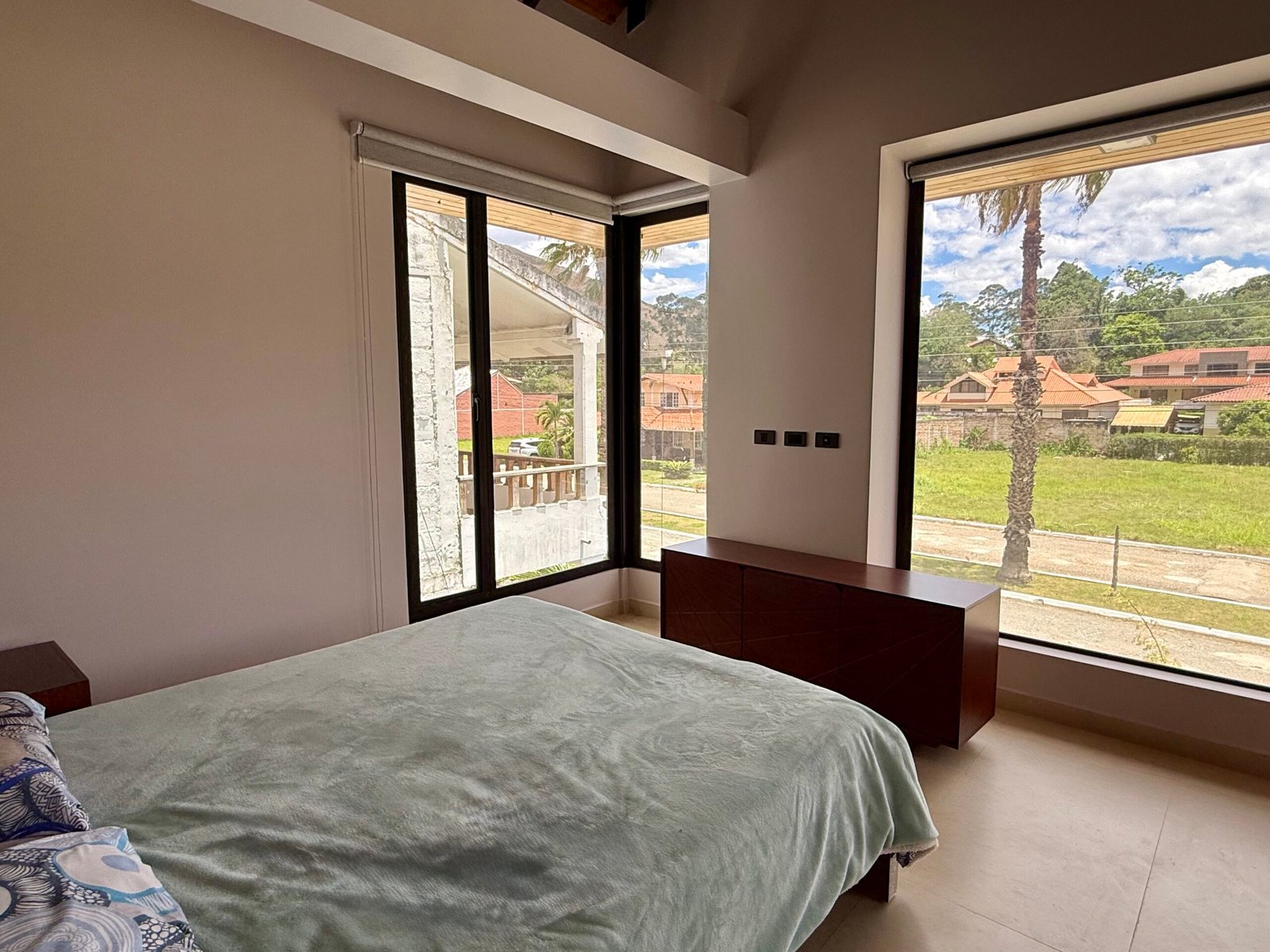 Bedroom with floor-to-ceiling windows and garden access